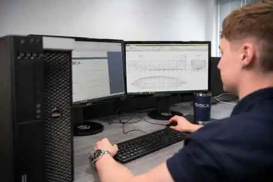 Marine engineer reviewing vessel geometry and naval design drawings